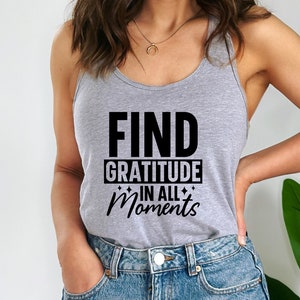 May include: A gray tank top with the text "FIND GRATITUDE IN ALL MOMENTS" printed in black.