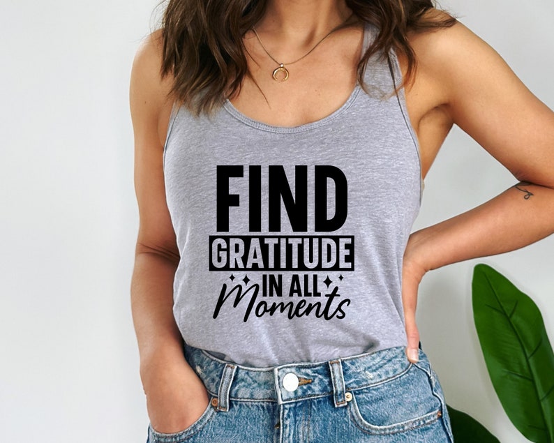 May include: A gray tank top with the text "FIND GRATITUDE IN ALL MOMENTS" printed in black.