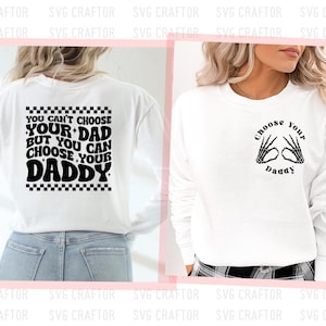 May include: Two white long-sleeve shirts with black text and graphics. The first shirt says "You can't choose your dad but you can choose your daddy" with a checkered pattern. The second shirt says "Choose your daddy" with two skeleton hands making a heart shape.