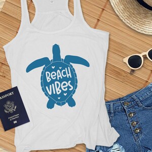 May include: White tank top with a blue sea turtle graphic and the text "Beach Vibes".