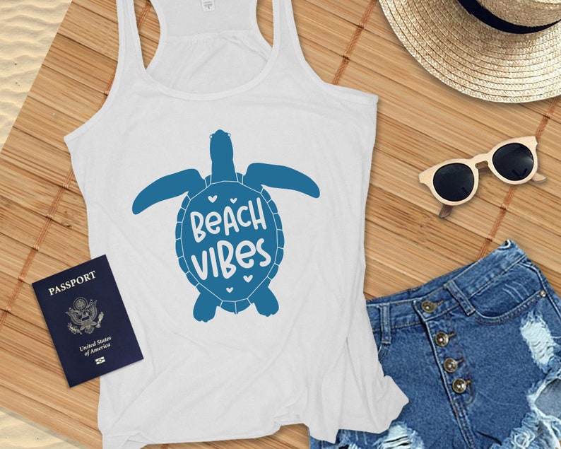 May include: White tank top with a blue sea turtle graphic and the text "Beach Vibes".