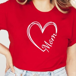 May include: Red t-shirt with a white heart design and the word "Mom" inside the heart.