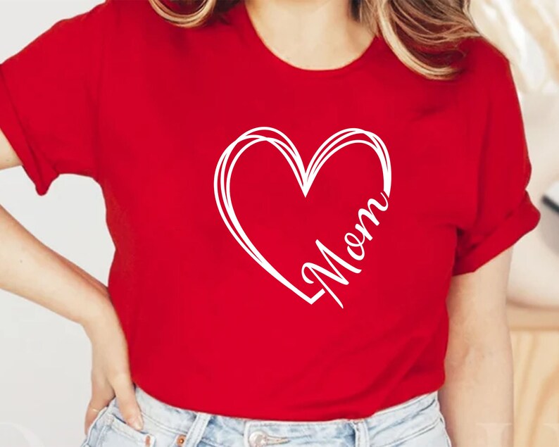 May include: Red t-shirt with a white heart design and the word "Mom" inside the heart.