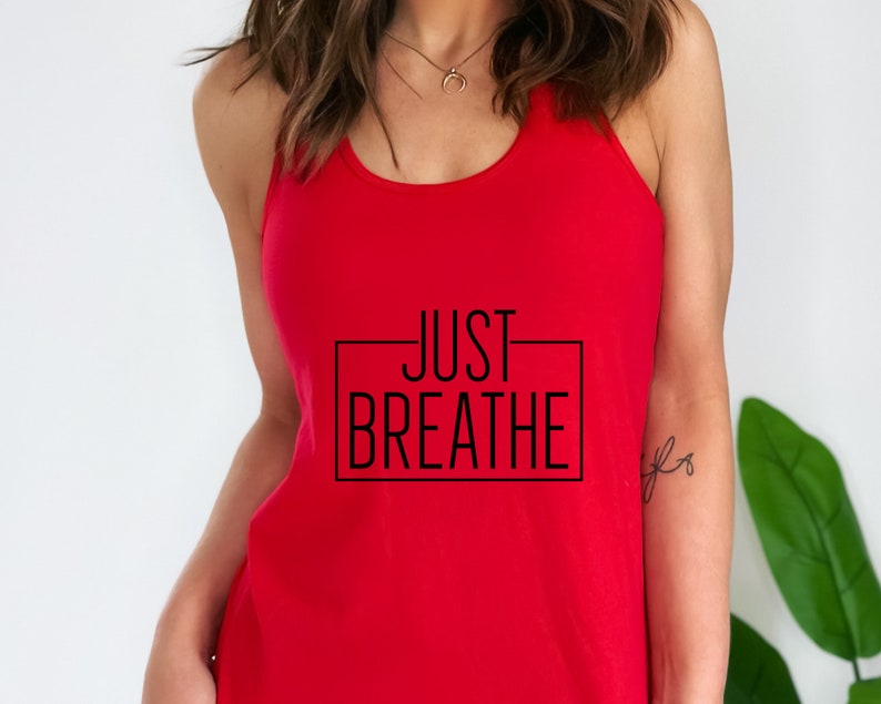 May include: Red tank top with a black graphic that says "JUST BREATHE" in a rectangle.