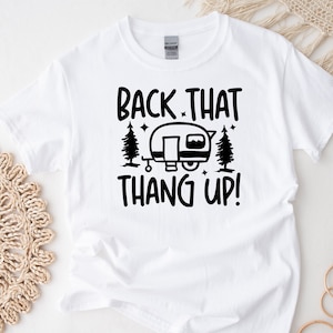 May include: White t-shirt with black text that reads "Back That Thang Up!" and a black silhouette of a camper with trees and stars.