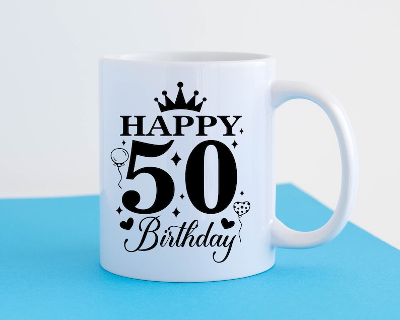 May include: White ceramic mug with a black design that says "Happy 50th Birthday" with a crown, hearts, and balloons.