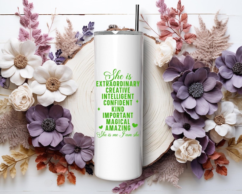 May include: White stainless steel tumbler with a green inscription that reads "She is Extraordinary Creative Intelligent Confident Kind Important Magical Amazing She is me I am she".