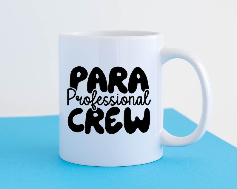 May include: White ceramic mug with a black design that says "Para Professional Crew".
