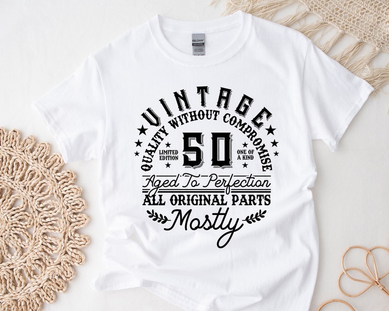 May include: White t-shirt with black text that reads "Vintage Quality Without Compromise 50 Aged To Perfection All Original Parts Mostly".