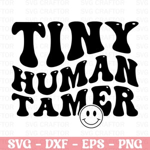 May include: Black and white graphic design with the words "TINY HUMAN TAMER" in a retro font, with a smiley face below. The bottom of the image includes the text "SVG - DXF - EPS - PNG".