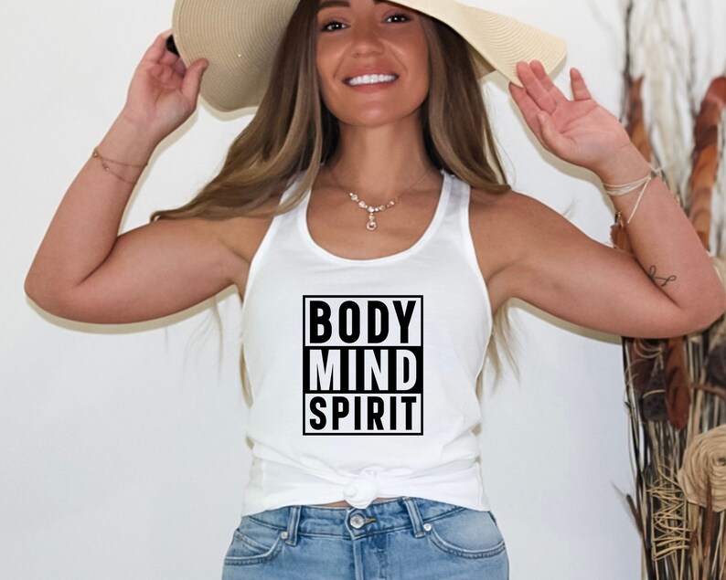 May include: White tank top with the words "BODY MIND SPIRIT" in a black box on the front.