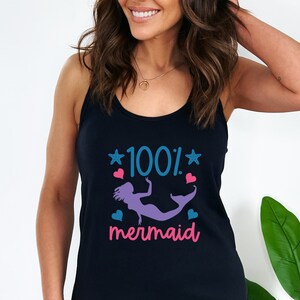 May include: A black tank top with a graphic design of a mermaid with the text "100% mermaid" in blue and pink.