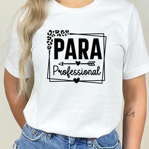 May include: White t-shirt with a black graphic that says "PARA Professional" with a leopard print design and an arrow with hearts.