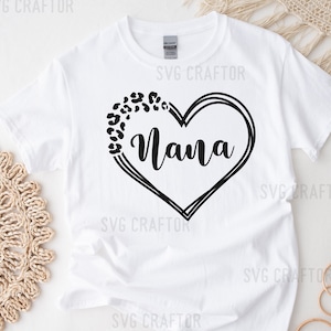 May include: White t-shirt with a black heart design featuring the word "Nana" and a leopard print pattern.