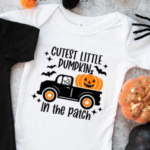 May include: White onesie with a black truck carrying a pumpkin and the text "Cutest Little Pumpkin in the Patch".