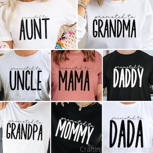 May include: Collection of white, gray, black, and pink t-shirts with the phrases "promoted to Aunt", "promoted to Grandma", "promoted to Uncle", "promoted to Mama", "promoted to Daddy", "promoted to Grandpa", "promoted to Mommy", and "promoted to Dada" in bold, black font.