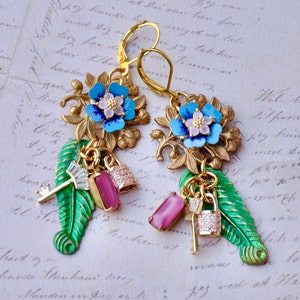 Blue Art Deco/Shabby Chic Drop/Dangle Earrings Made With A Gold Floral Finding With A Blue Flower And A Green Leaf With Lock And Key Charms.