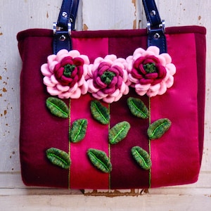Shabby Chic Handbag Made From Burgundy And Magenta Wool Fabric With Pink And Burgundy Wool Flowers And Green wool leaves. With Black Handles
