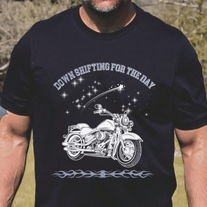 May include: Black t-shirt with a white graphic of a motorcycle and the text "Down Shifting For The Day".