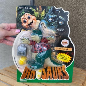 Earl Sinclair figure toy 1991 new old stock on card, vintage Baby Sinclair dinosaur family pvc official figurine TV series Dinosaurs