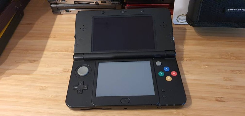 New Nintendo 3ds black edition. With free games.Original.Super condition. Vintage game with charger. .Region free . 5000 games image 1