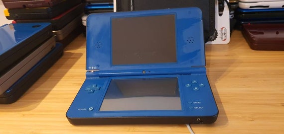 Nintendo DSi XL with original games, charger and case 