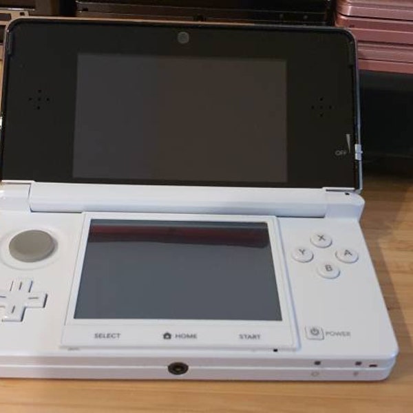 Custom  Nintendo 3ds white edition. With 250 free games. Original. used condition. Vintage game with charger. Free case. Region free .