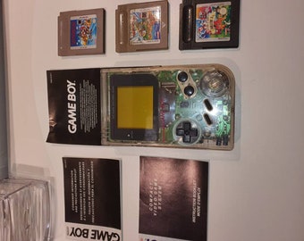 Originele dmg transparante gameboy . Gebruikt maar in goede staat. Met gratis originele mario games.