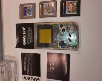 Original dmg transparant gameboy . Used but in good condition. With free original mario games.