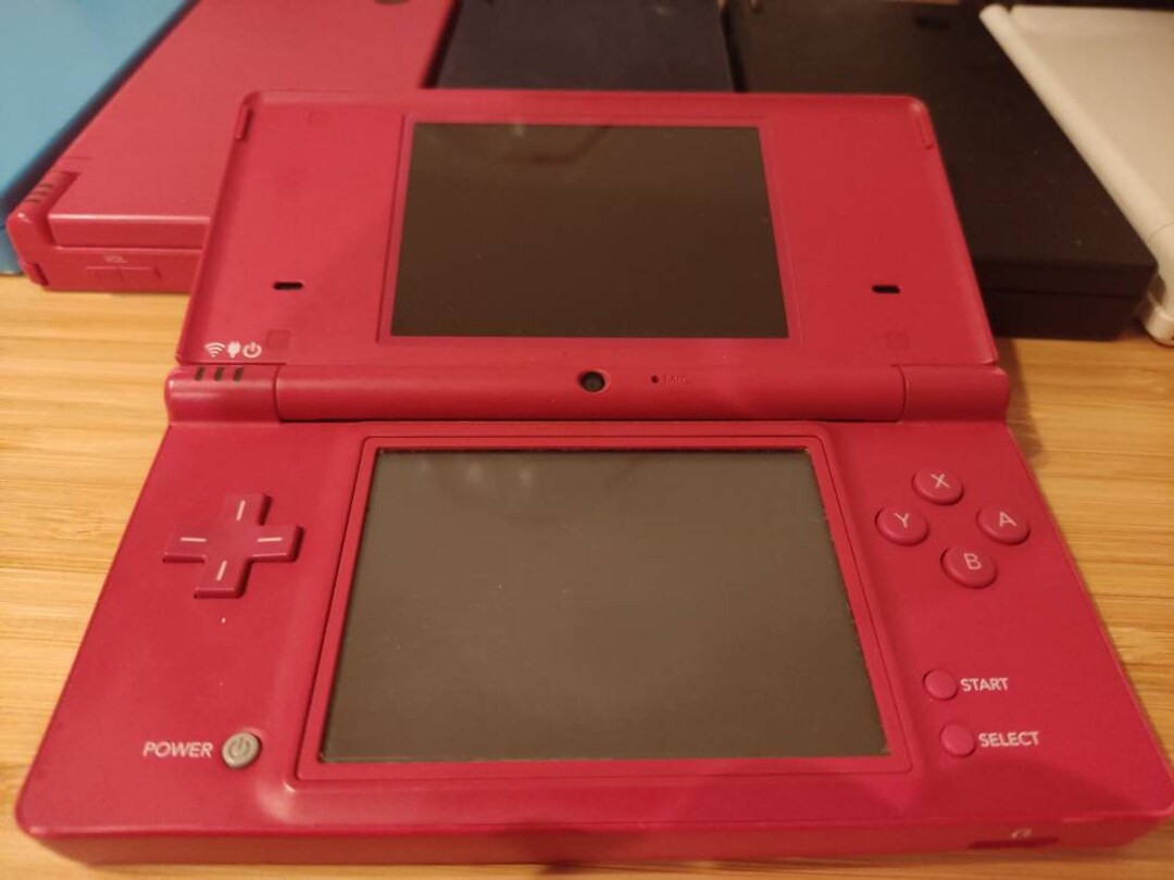 Nintendo DSi XL with original games, charger and case 