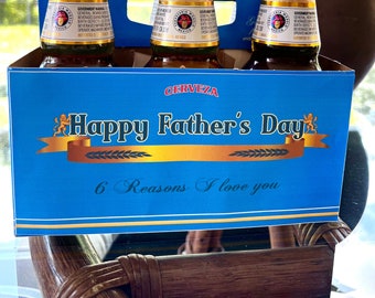 Può includere: Un pacco da sei birre blu e oro con il testo "Happy Father's Day" e "6 Reasons I love you".