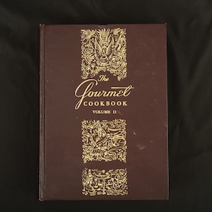 May include: The Gourmet Cookbook Volume II, a brown hardcover book with gold lettering and illustrations of food and drink.