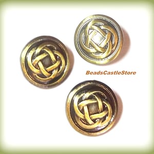 May include: Three gold-toned metal buttons with a Celtic knot design. The buttons have a raised, textured design and a dark brown background.