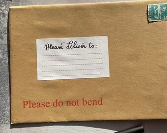 May include: A brown envelope with a white label reading "Please Deliver to:" in cursive. Below, the text "Please do not bend" is printed in red. Vintage stamps and a black pen are also visible on the surface.