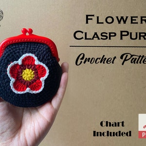 May include: A black crochet purse with a red flower design and a red metal clasp. The purse is held in a hand. The text "FLOWER CLASP PURSE Crochet Pattern Chart Included PDF" is visible in the image.