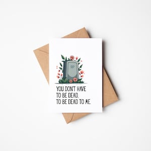 May include: A white greeting card with a tombstone illustration, surrounded by flowers and greenery, and the text "YOU DON'T HAVE TO BE DEAD, TO BE DEAD TO ME." The card is on a brown envelope.