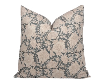May include: A decorative throw pillow with a floral pattern in shades of pink and blue. The pillow is made of a soft, linen fabric.