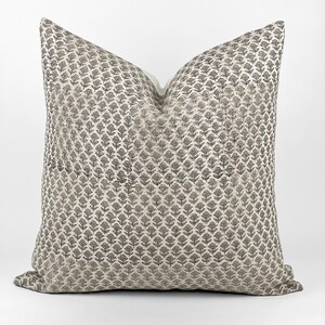 May include: A decorative throw pillow with a white background and a black floral pattern.