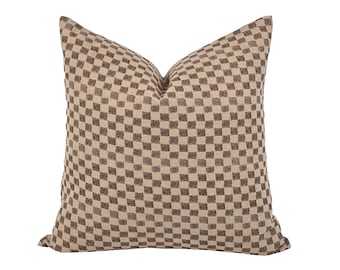 May include: A brown and beige checkered throw pillow with a subtle textured fabric.
