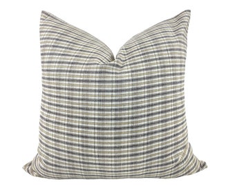 May include: A decorative throw pillow with a black, white, and beige plaid pattern.