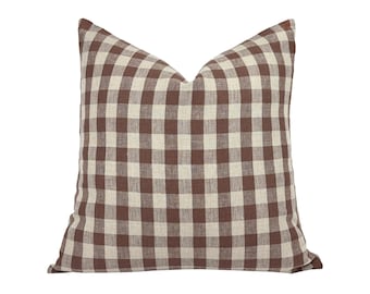 May include: A brown and white gingham pillow cover. The pillow cover is made of a soft, woven fabric and has a square pattern.