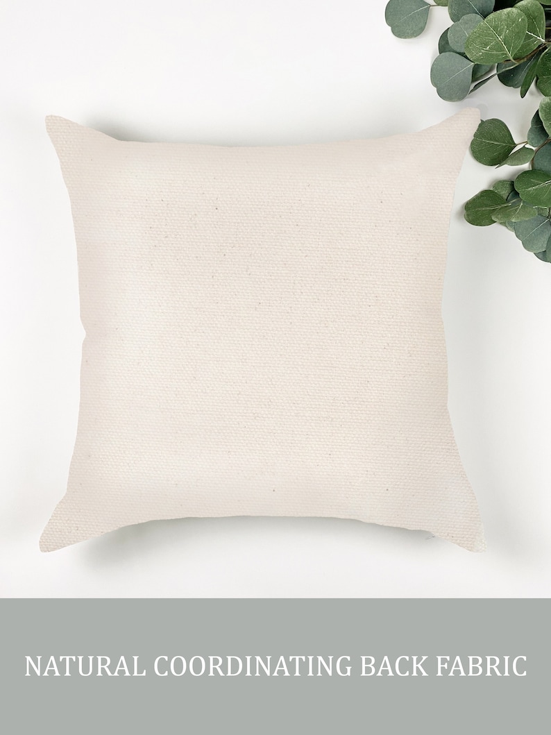 May include: A plain white pillow cover with a natural fabric back. The pillow cover is made of a soft, woven fabric.