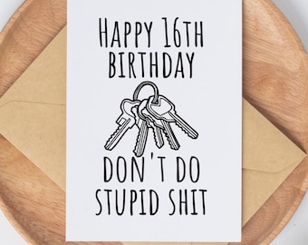 May include: A white greeting card with the text "HAPPY 16TH BIRTHDAY DON'T DO STUPID SHIT" and a key illustration. The card is on a brown envelope, placed on a wooden plate, with cotton buds in the background.