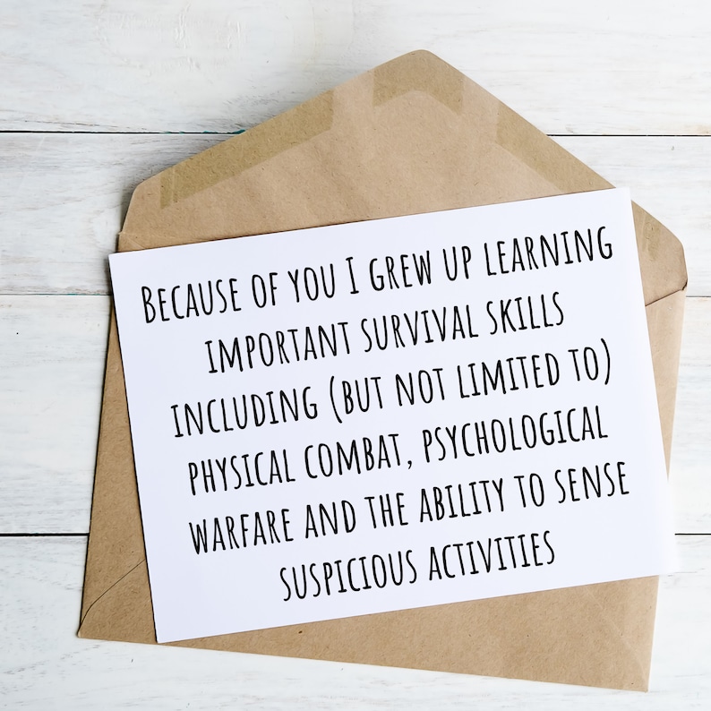 May include: A white card with black text in a brown envelope. The text reads: "Because of you I grew up learning important survival skills including (but not limited to) physical combat, psychological warfare and the ability to sense suspicious activities."