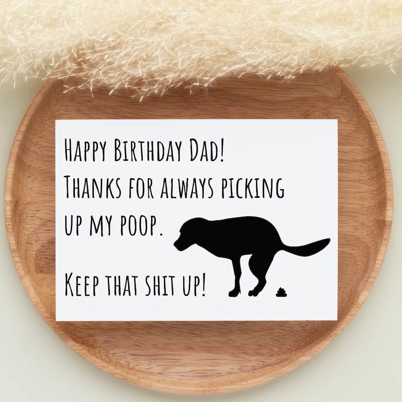 Birthday Card for Dog Dad A white greeting card with a black silhouette picture of a dog pooping. It reads 'Happy Birthday Dad! Thanks for always picking up my poop. Keep that shit up!'