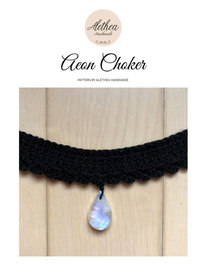 May include: A black crocheted choker necklace with a teardrop-shaped iridescent gemstone pendant. The choker is on a wooden surface.  Aeon Choker. Pattern by Alethea Handmade.