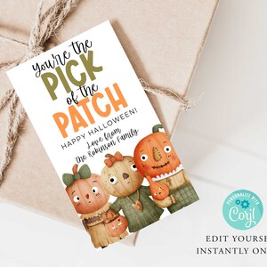 May include: A white card with orange and green text that reads "You're the PICK of the PATCH HAPPY HALLOWEEN! Love from The Robinson Family". The card features a cartoon illustration of three pumpkins with faces.