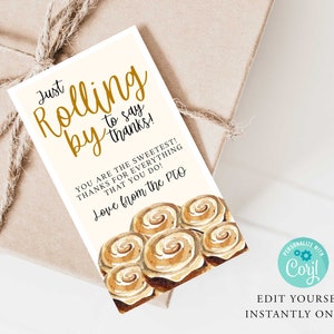 May include: A white card with gold lettering that says "Just Rolling by to say thanks!" and "You are the sweetest! Thanks for everything that you do! Love from the PTO". The card has a watercolor illustration of cinnamon rolls.