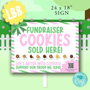 May include: A sign that reads "Fundraiser Cookies Sold Here!" in pink and green, with a green bow and a yellow flower with "LBB" on it. The sign is 24 x 18 inches and has a white picket fence background.