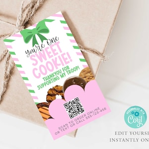May include: A gift tag with a green bow and the text "You're One Sweet Cookie! Thank you for supporting my troop!" is attached to a wrapped gift. The tag has pink and green stripes and a QR code.